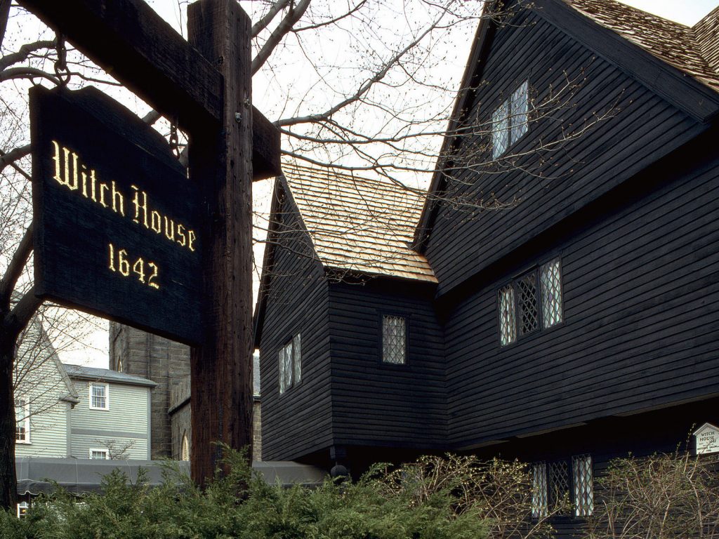 photo shows the exterior of the salem witch house and a sign that reads "salem witch house, 1642."